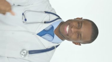 Vertical Video of Thumbs Up by Young African Doctor on White Background