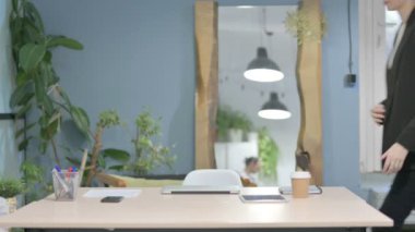 Young Businesswoman Coming Back to Office and Opening Laptop