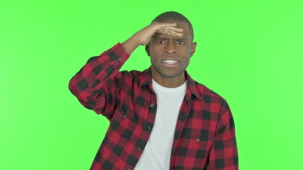 Young African Man Looking Searching Green Background — Stock video