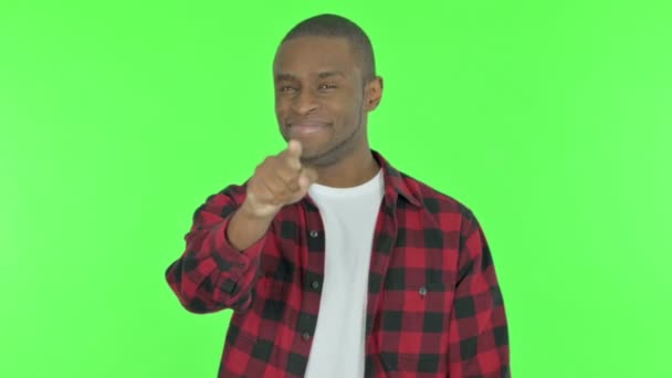 Young African Man Pointing Camera Green Background — Stock Video