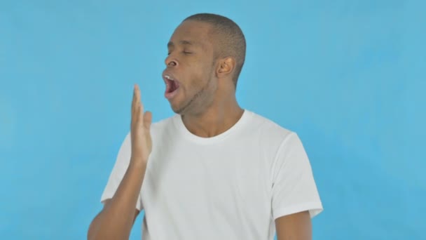 Yawning Young African Man Blue Background — Stock video