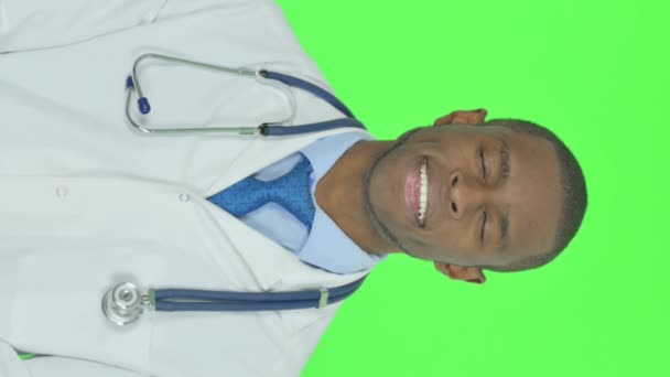 Vertical Video Smiling Young African Doctor Green Background — Stockvideo