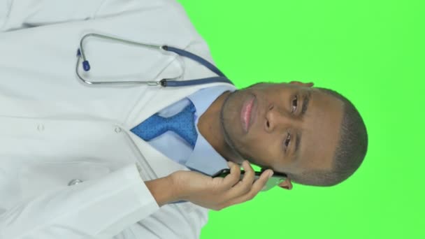 Vertical Video Young African Doctor Talking Phone Green Background — Video