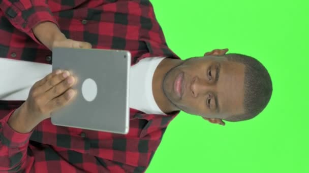 Vertical Video Young African Man Using Digital Tablet Green Background — Stock video