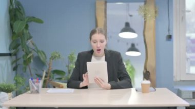 Shocked Young Businesswoman Reacting to Loss on Digital Tablet