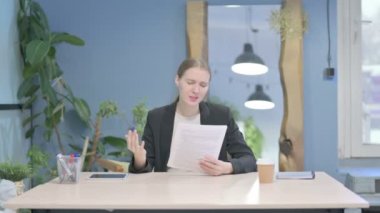 Young Businesswoman Feeling Upset after Reading Documents, Paperwork