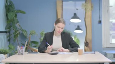 Young Businesswoman Working on Documents, Calculating Business Data