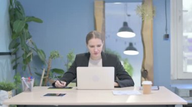 Female Graphic Designer Working on Laptop and Graphic Tablet