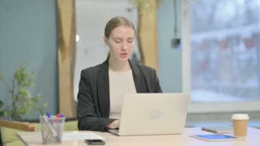 Young Businesswoman Reacting to Loss While Working in Office