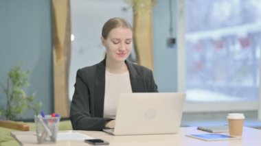 Thumbs Down by Young Businesswoman Working on Laptop