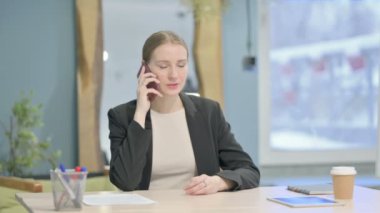 Upset Young Businesswoman Talking Angrily on Smartphone