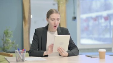 Shocked Young Businesswoman Reacting to Loss on Digital Tablet