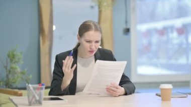 Young Businesswoman Feeling Upset after Reading Documents, Paperwork