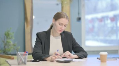 Young Businesswoman Working on Documents, Calculating Business Data
