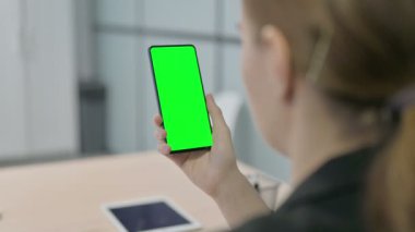 Young Businesswoman Using Smartphone with Green Screen