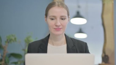 Close Up of Young Businesswoman with Thumbs Up at Work