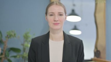Kameraya gülümseyen genç iş kadınının portresi