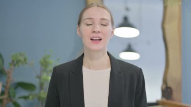 Young Businesswoman with Finger on Lips, Asking for Silence