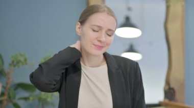 Tired Young Businesswoman Stretching Body and Massaging Her Neck