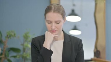 Portrait of Young Businesswoman Sleeping while Sitting in Creative Place