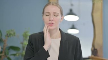 Portrait of Young Businesswoman having Toothache at Work