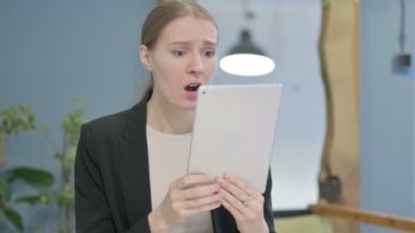 Shocked Young Businesswoman Reacting to Loss on Digital Tablet