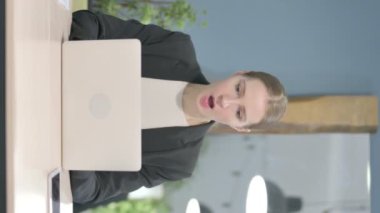 Vertical Video of Young Businesswoman Shocked by Loss on Laptop