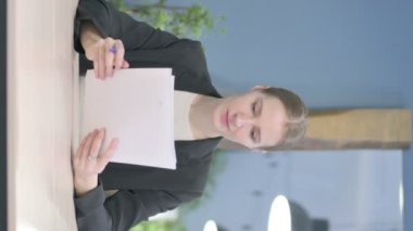 Vertical Video of Young Businesswoman Reading Documents