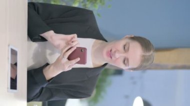 Vertical Video of Young Businesswoman Celebrating Success on Smartphone