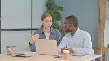 Caucasian Businesswoman Talking with African American Man