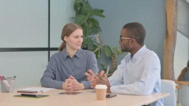 Young Business People Discussing Work in Office