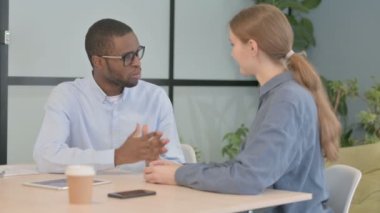 Young Business People Discussing Work with Partner