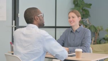 Young Woman Talking to African American Man in Office