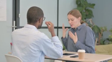 Angry Woman Fighting with African American Man in Office