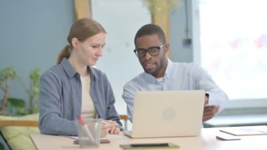 Mixed Race Young Business People Discussing Work on Laptop