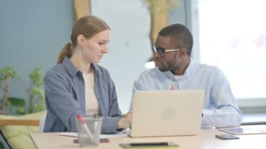 African American Man Talking with Businesswoman, Discussing Paperwork