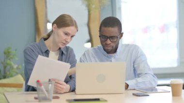 African American Man and Businesswoman Doing Paperwork Together