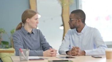 Young Business People Discussing Work in Office