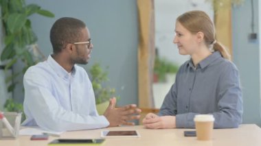 Young African American Man Discussing Work with Partner