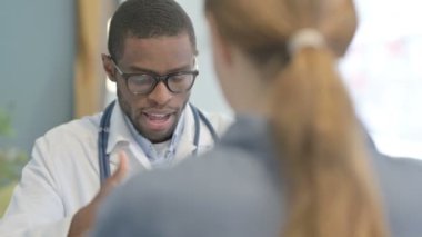African American Doctor Talking with Female Patient