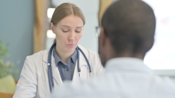 Female Doctor Consulting Black African American Man — Stockvideo