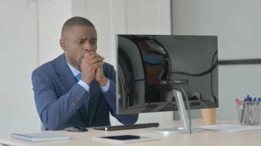 Young African Businessman Reacting to Loss While Working on Computer