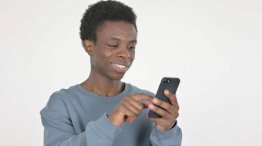 Casual African Man Browsing Smartphone on White Background