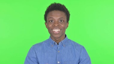 Successful Casual African Man Celebrating on Green Background