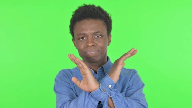 Disliking Casual African Man in Denial on Green Background