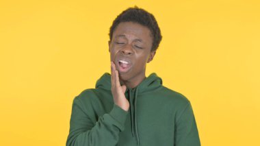 Casual African Man having Toothache on Yellow Background