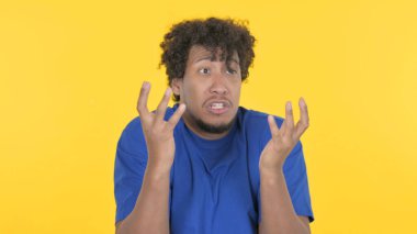 Casual African Man Shouting and Screaming on Yellow Background