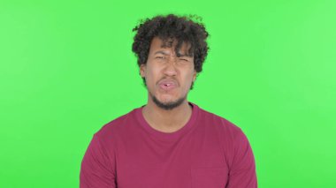 Disappointed Casual African Man Reacting Loss on Green Background