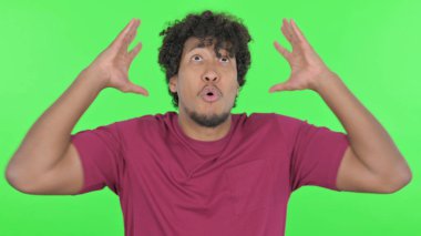 Screaming Casual African Man Going Crazy on Green Background