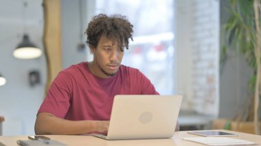 Busy Young African Man Typing on Laptop in Office